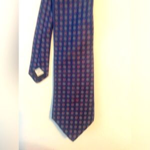 Claiborne tie. Dark blue with red and golden accents.